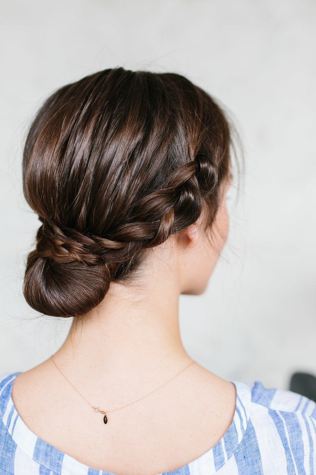 A woman wearing a braided bun