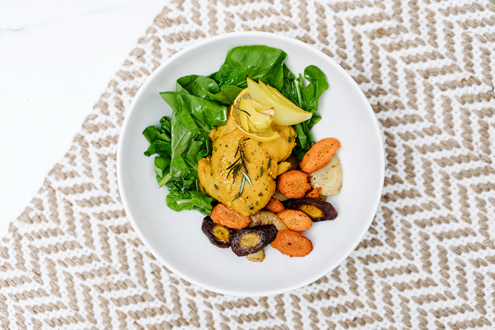 lemon garlic chicken served on a white plate with vegetables