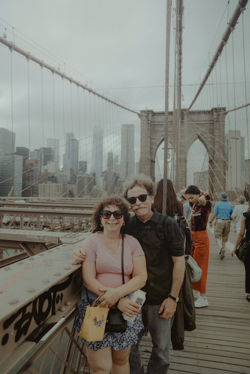 A couple standing on Brooklyn Bridge