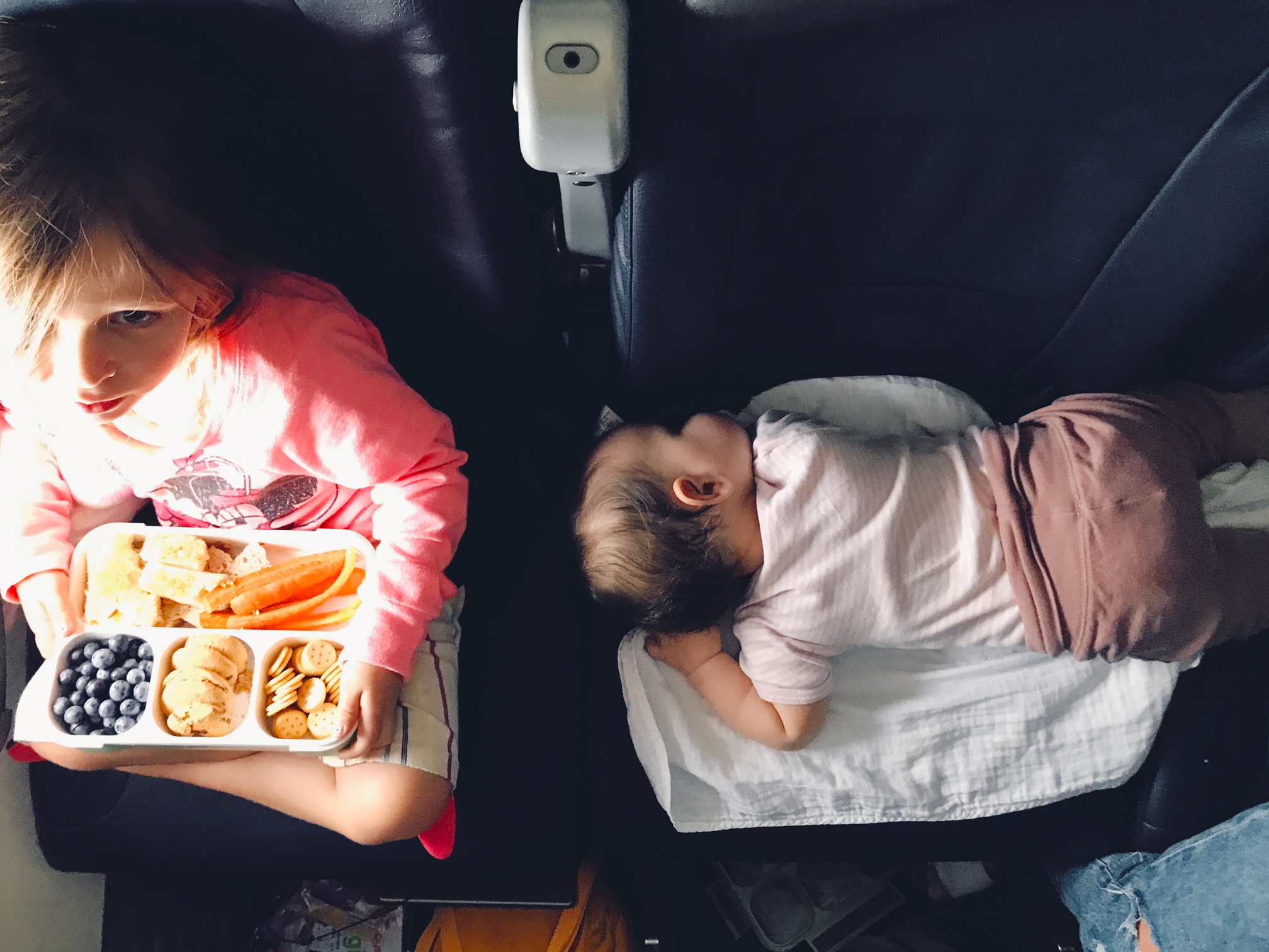 Kids in plane seats while travelling to new york city