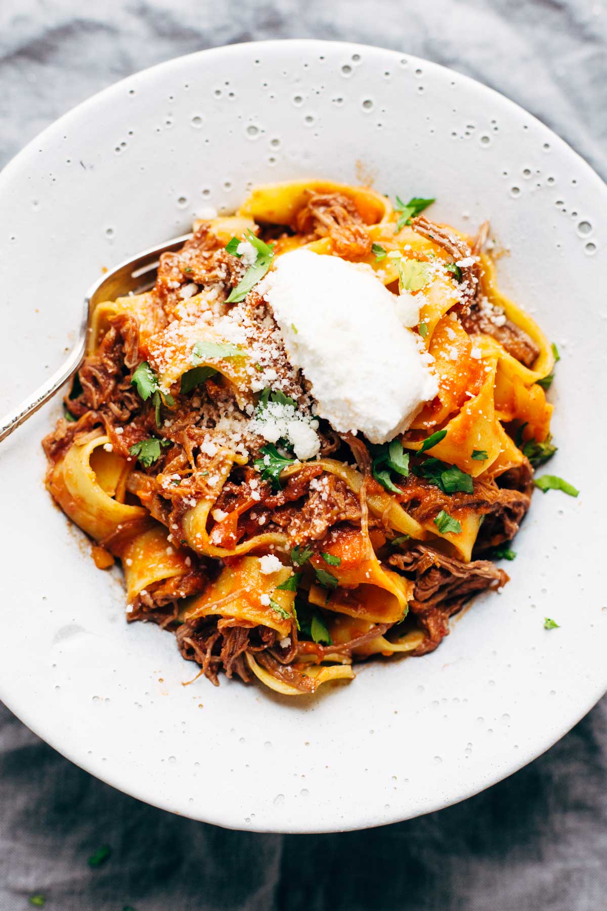 a fall comfort food recipe - beef ragu served on a white plate