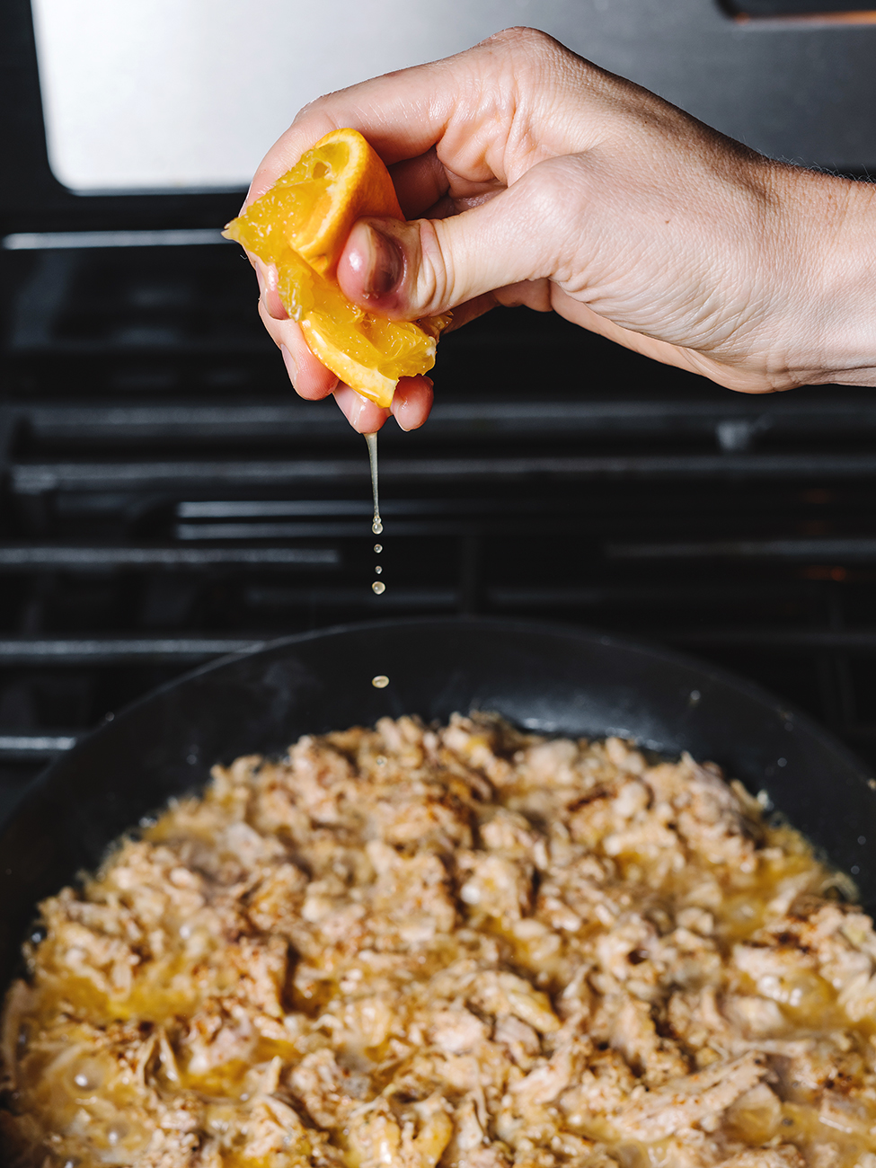 squeezing orange onto pulled pork