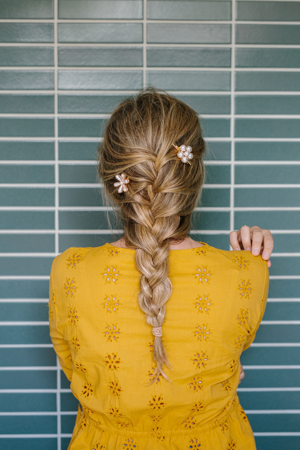 Full length shot of a women in a yellow top with a french braid