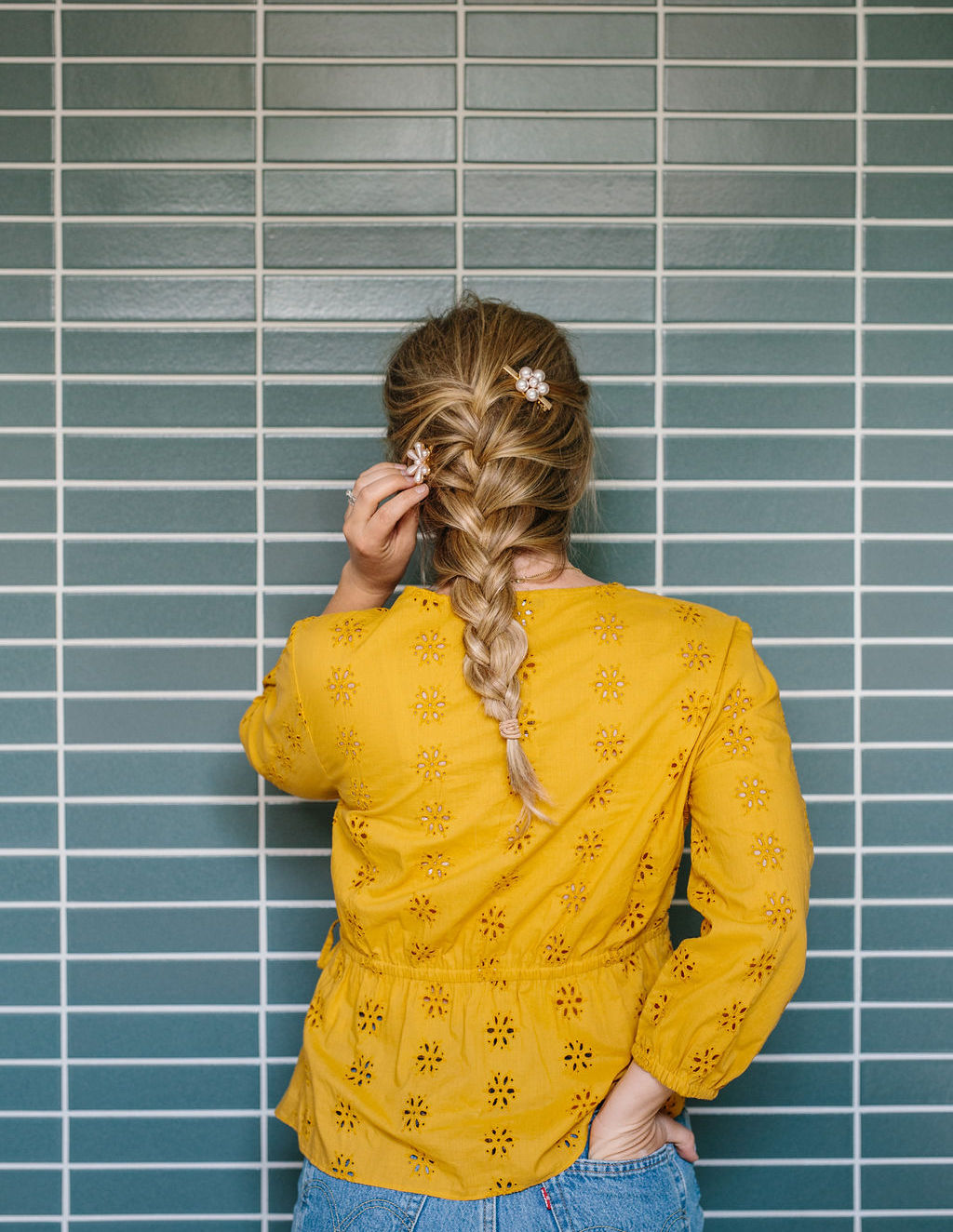 A women with a French braid touching the back of the hair