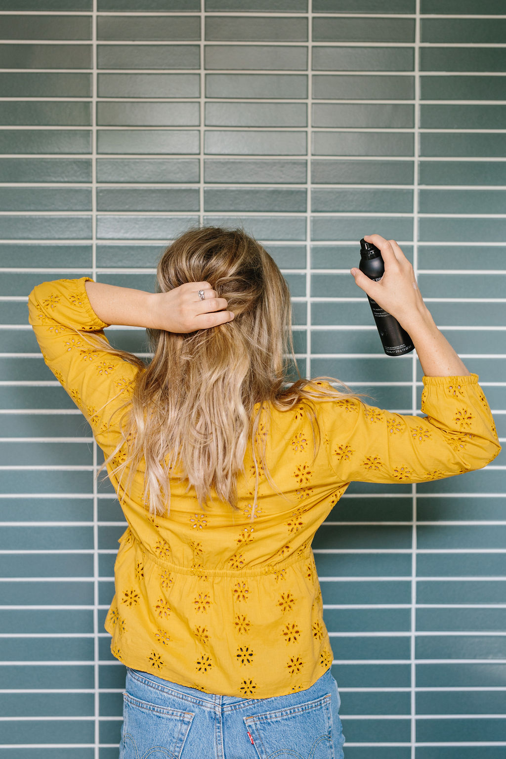 Hair being sprayed with hairspray