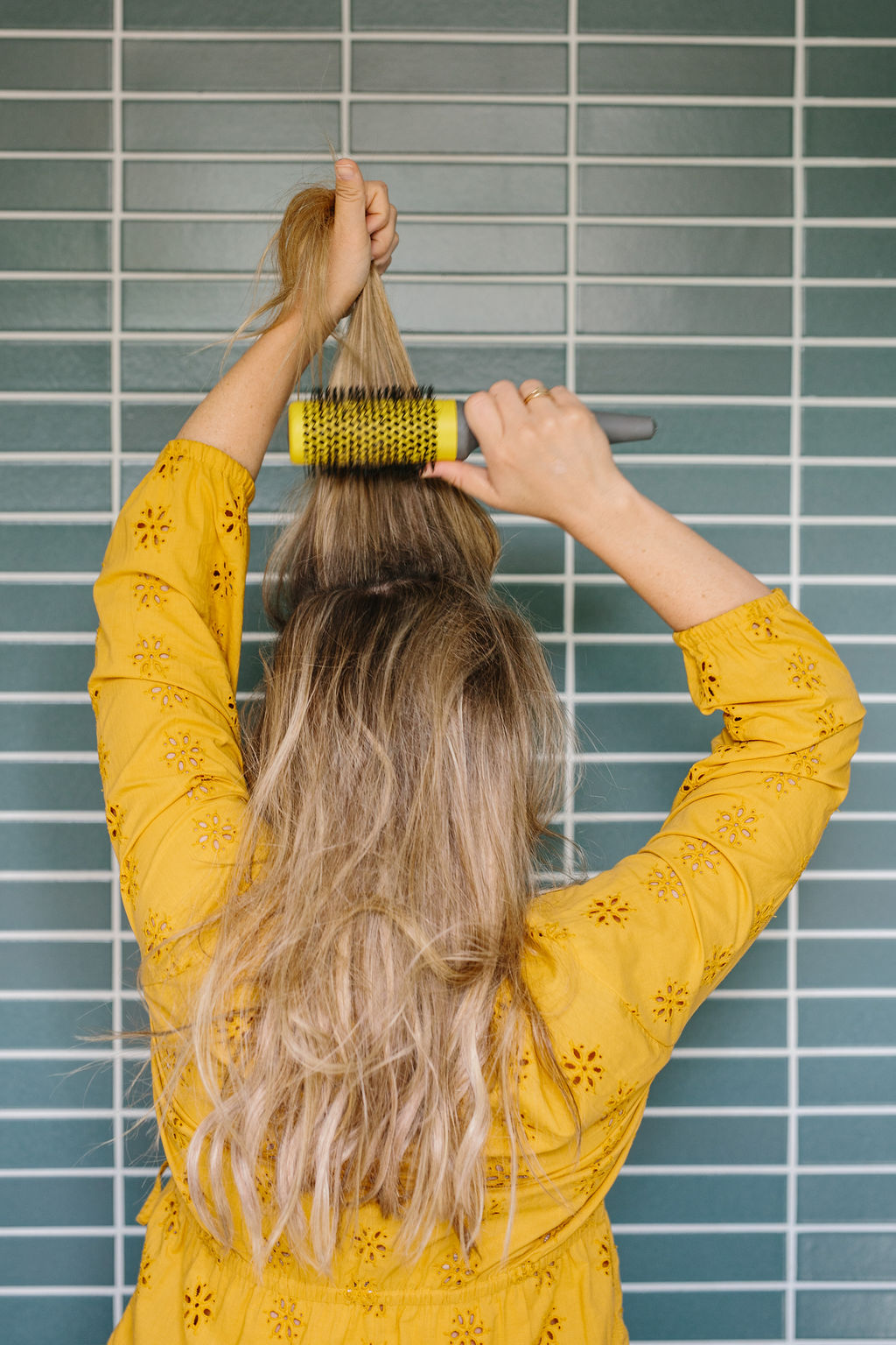 Back combing the top of the hair with a rounded brush 