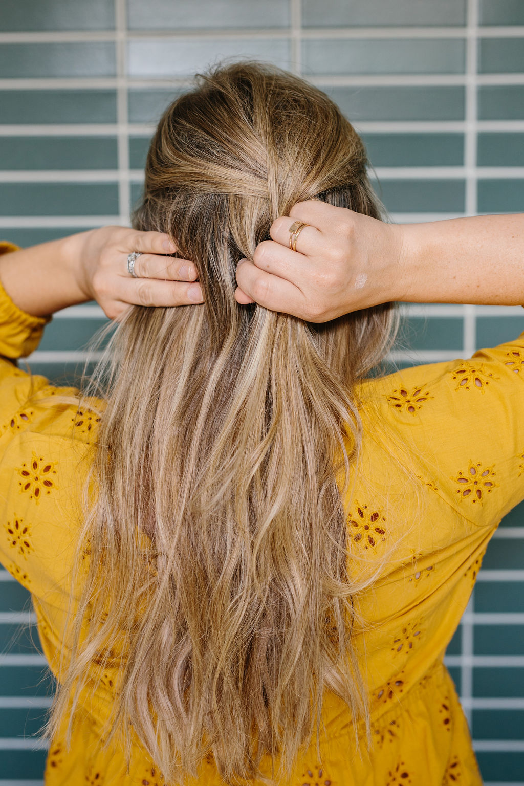 Hands separating sections of the hair