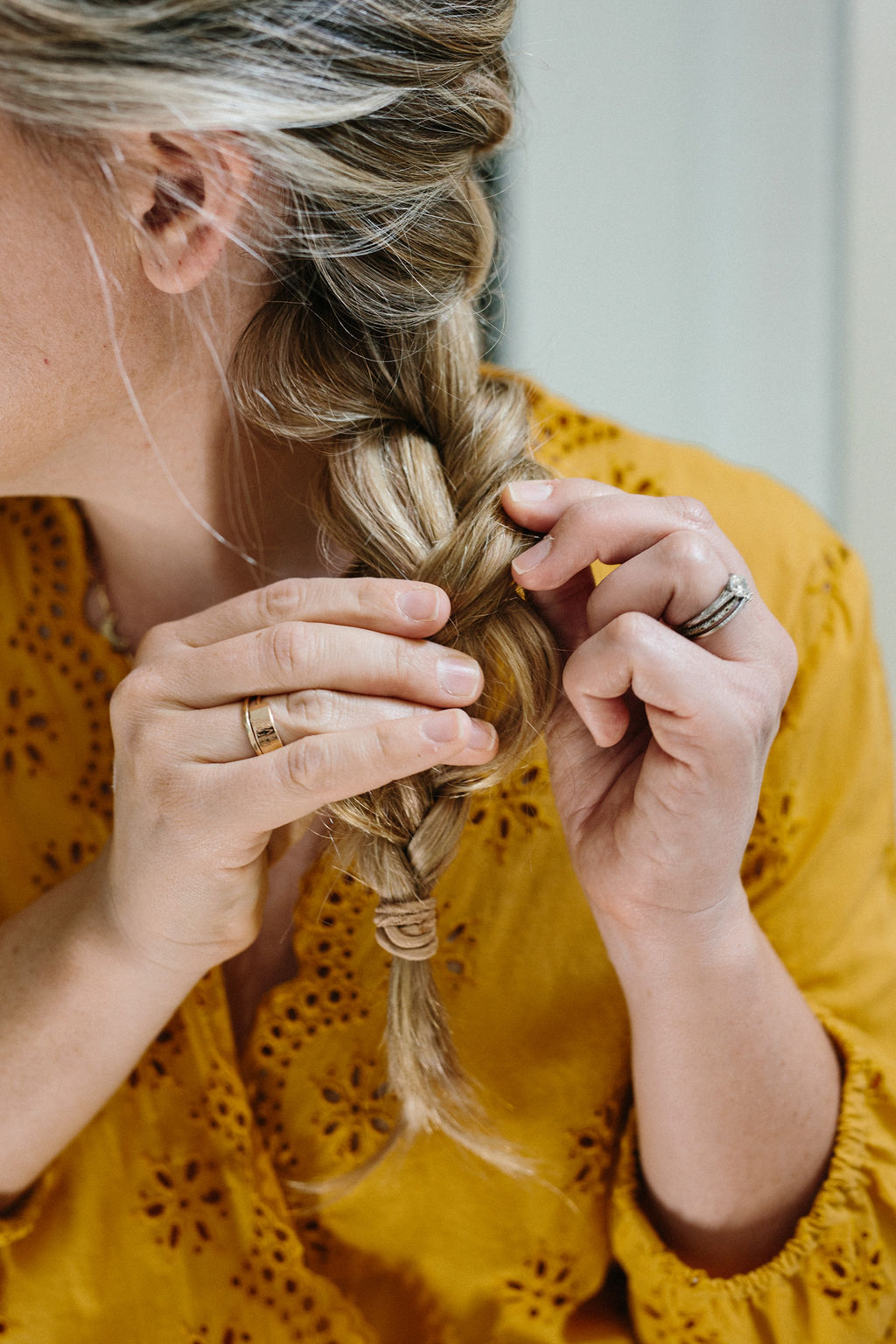 Teasing the end of the French braid to make it fuller