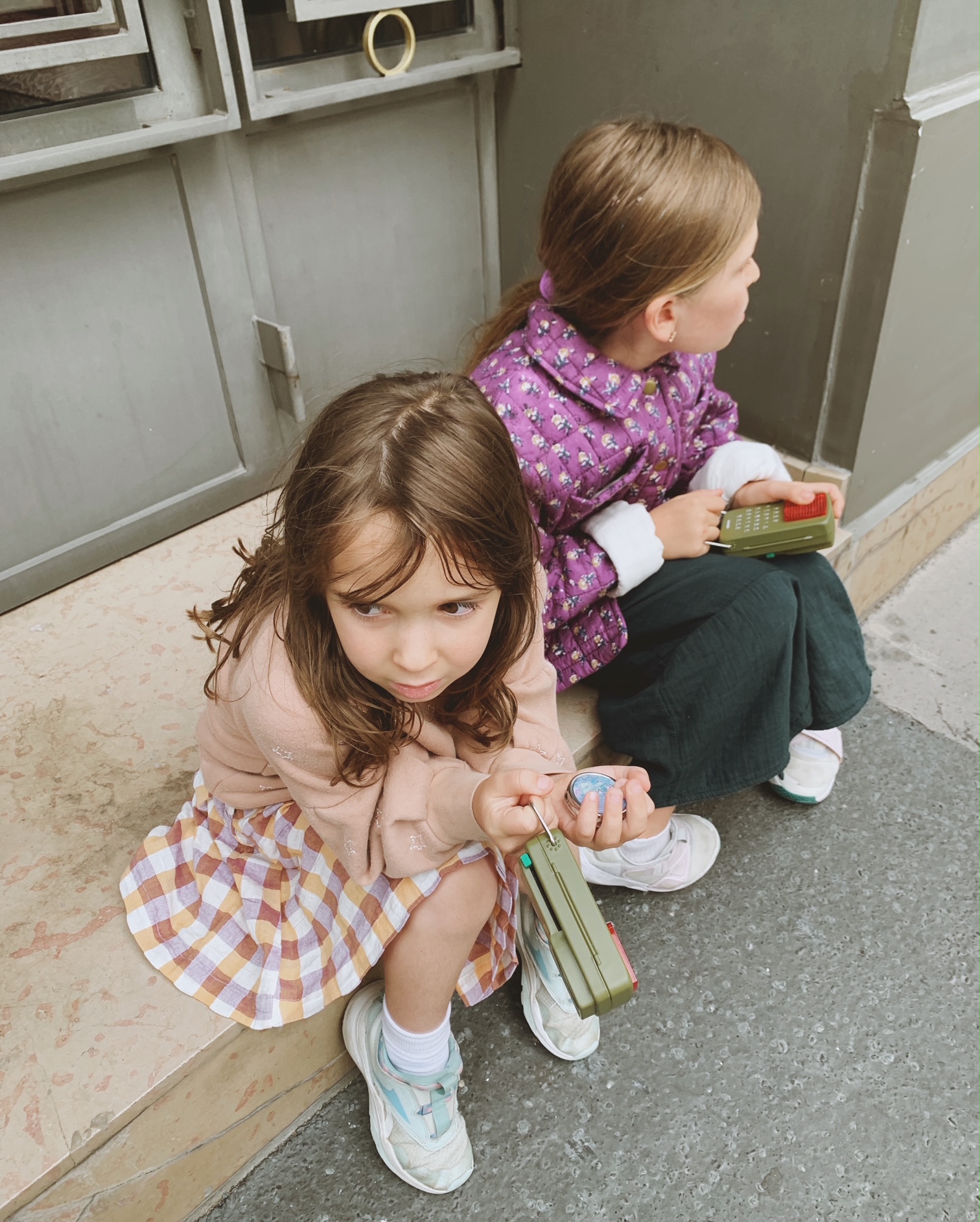 Kids taking a break on a stoop in Paris