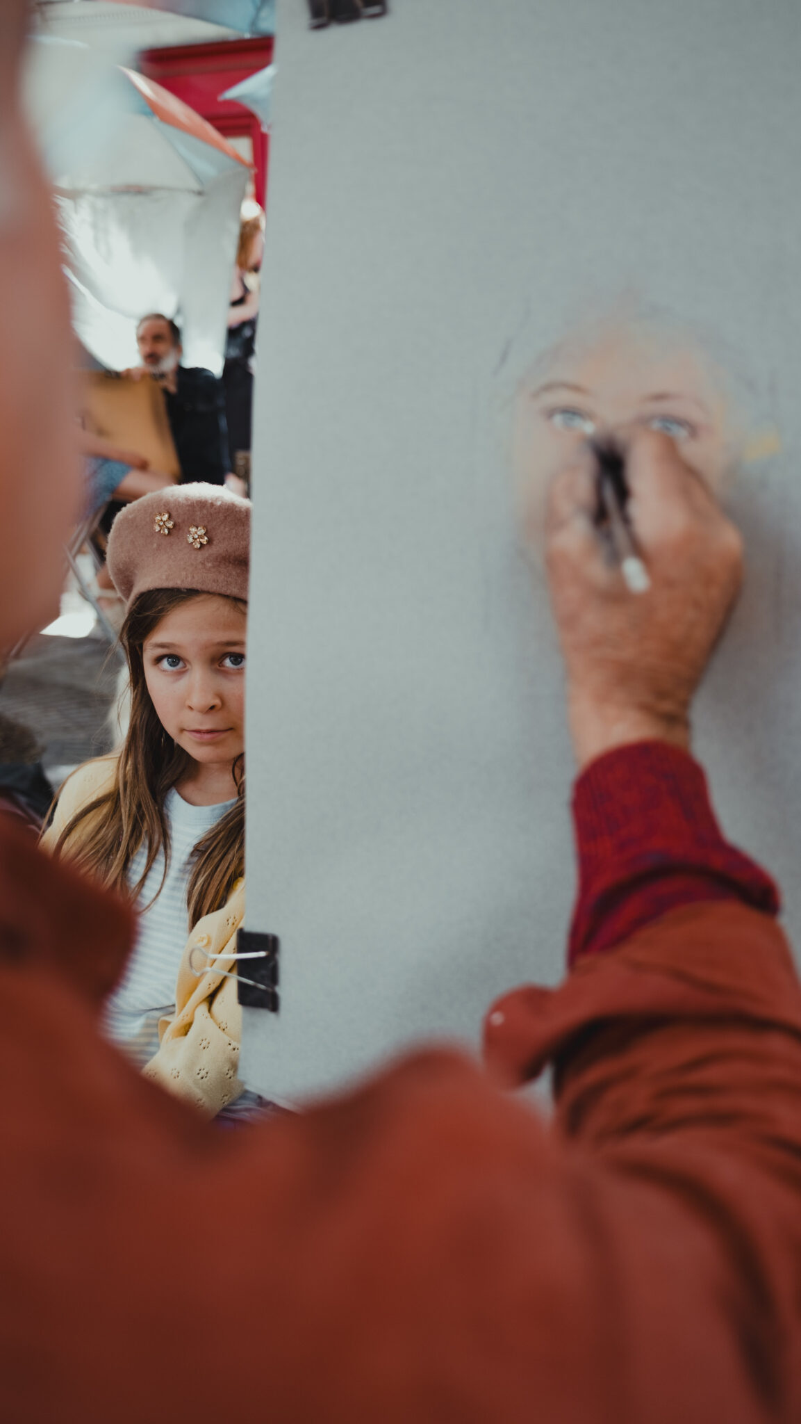 Girl having her portrait drawn in Montmartre