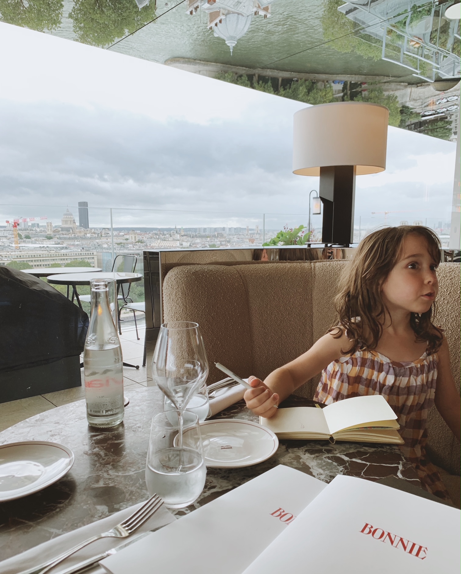 Table at Bonnie in Paris with a view of the Eiffel Tower. Kid-friendly Restaurant!