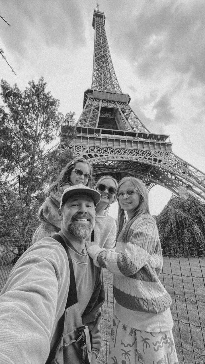 Family of two children in front of the Eiffel Tower in Paris